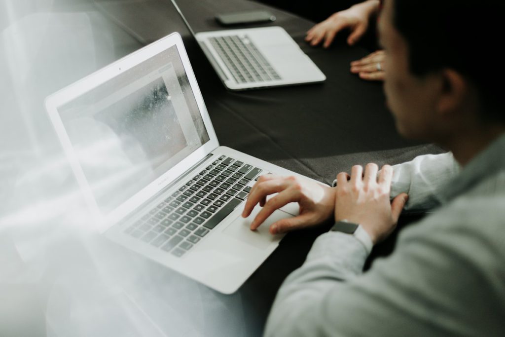 SEO expert in Bangladesh working on keyword research and site optimization on a laptop