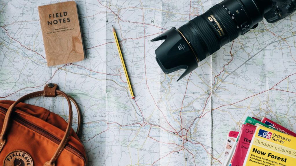 Travel agency SEO services – travel planning with map, camera and passport for tour bookings online